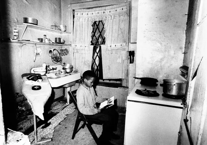 Framed Print : African American youth studies by the kitchen stove because his apartment, like the others in his buildings, is without heat Framed Print : African American youth studies by the kitchen stove because his apartment, like the others in his buildings, is without heat