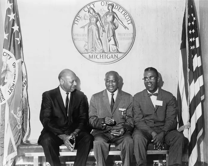 Framed Print : Three African Americans, poets Dudley Randall (1914-2000) and Melvin Beaunorus Tolson (1898-1966), with Olivier LaGroan seated on bench below seal of the Detroit, Michigan. 1965