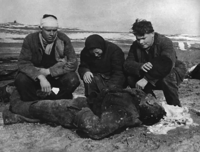 Framed Print : Aftermath of a German massacre of Soviets (Russians) in the Kerch Peninsula, Crimea. The Polyarush family kneel beside the body of their father, 68-year-old Illarion Framed Print : Aftermath of a German massacre of Soviets (Russians) in the Kerch Peninsula, Crimea. The Polyarush family kneel beside the body of their father, 68-year-old Illarion