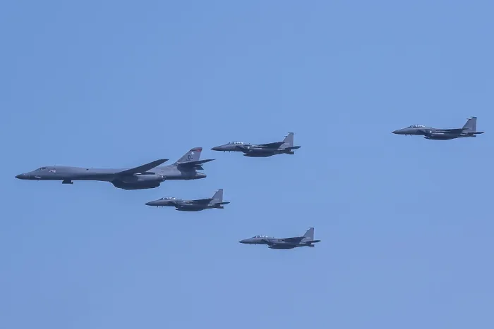 Framed Print : US Air Force B-1B Lancer, escorted by South Korean air force F-15K Slam Eagles, Sept. 13, 2016. The allied aircraft fly over Osan Air Base, South Korea, Sept