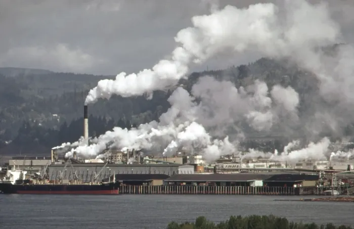 Framed Print : Air pollution is visible from the Weyerhaeuser paper mills and Reynolds metal plant both located in Longview Washington on the Columbia River. Ca. 1973-75