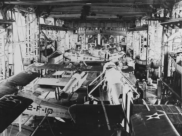 Framed Print : Aircraft in the USS Langleys hangar, during the 1920s. The larger plane in the foreground is a Douglas DT torpedo bomber, with its wings removed