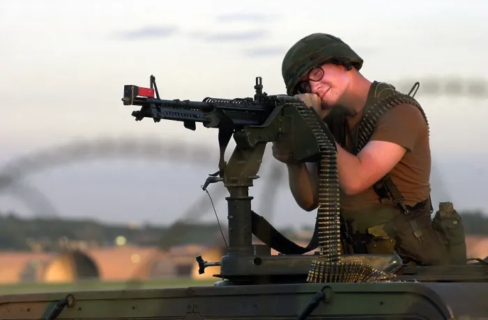 Framed Print : An airman mans a M-60 machine gun at a defensive firing position during training maneuvers at Osan Air Base, Republic of Korea, 7 / 26 / 2001
