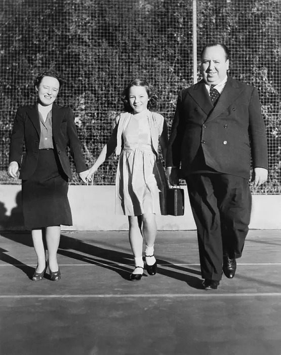 Framed Print : Alfred Hitchcock strolling about the grounds of his Bel Air estate. He is with his wife, Alma Reville, and his daughter, Patricia. Ca. 1942 - (BSLOC_2014_17_79)
