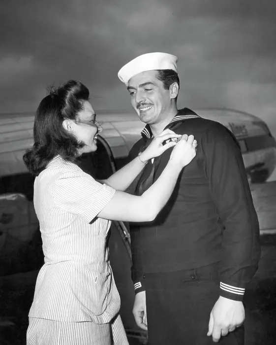 Framed Print : American actor and Coast Guardsman Victor Mature (right), receiving campaign ribbons from Juanita Ferrara (left), the Coast Guard Public Relations Secretary, 1943 Framed Print : American actor and Coast Guardsman Victor Mature (right), receiving campaign ribbons from Juanita Ferrara (left), the Coast Guard Public Relations Secretary, 1943