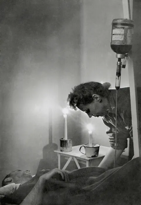 Framed Print : American Army nurse at candle lit bedside of wounded soldier in France during World War 2 Framed Print : American Army nurse at candle lit bedside of wounded soldier in France during World War 2