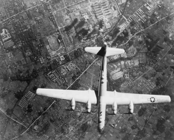 Framed Print : American B-29 Super Fortress bomber over Nakajima Aircraft Co. Musashino Plant, Japan. On the ground, smoke marks it's bombing impacts. 1945. World War 2. (BSLOC_2013_13_75)