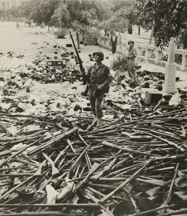 Framed Print : American M.P. standing on a large pile of Italian weapons on a street in Palermo, Italy, on August 6, 1943 Framed Print : American M.P. standing on a large pile of Italian weapons on a street in Palermo, Italy, on August 6, 1943