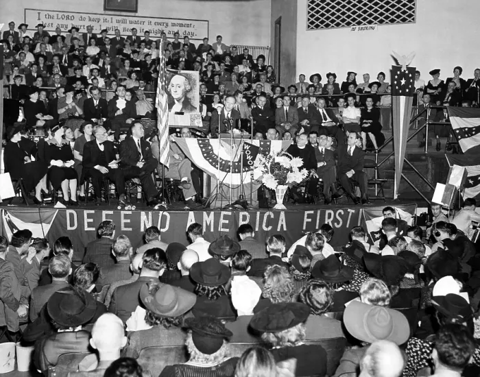Framed Print : American pilot Charles Lindbergh (center, behind flag), speaks before a crowd of 3, 000 at a Fort Wayne Indiana Rally in Gospel Temple. October 4, 1941