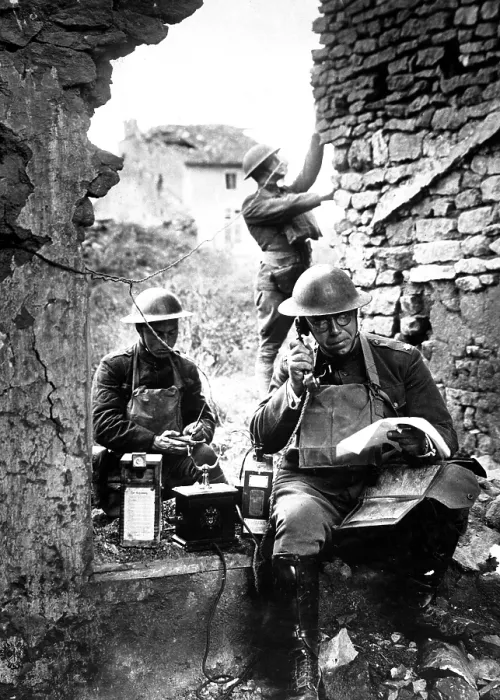 Framed Print : American signal officer of the 42nd Division, testing a telephone left behind by retreating Germans in the St. Mihiel salient. Essey, France. World War I. Sept. 19, 1918