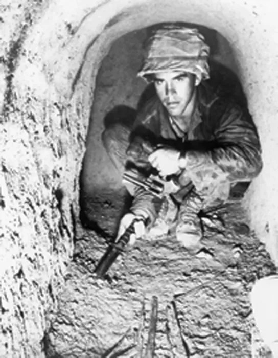 Framed Print : American soldier using a knife to probe the floor of a Viet Cong tunnel in the Iron Triangle north of Saigon, South Vietnam. Jan. 1967