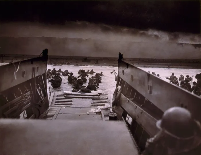 Framed Print : American soldiers wade from Coast Guard landing craft toward the Omaha Beach against machine gun fire on D-Day. June 6, 1944, by Coast Guard photographer, Robert F. Sargent