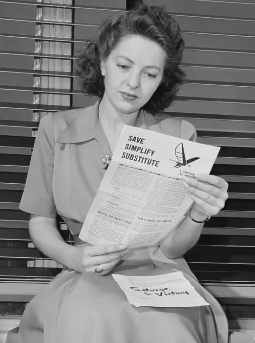 Framed Print : American woman reads a government brochure on titled Save, Simplify, Substitute Framed Print : American woman reads a government brochure on titled Save, Simplify, Substitute