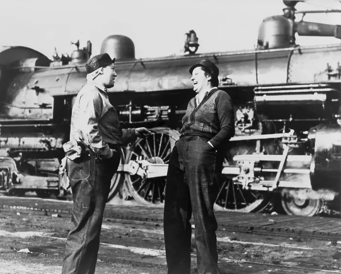 Framed Print : Two American women railroad workers talk after they have cleaned and prepared a locomotive for operation. They are women war workers during World War 2. (BSLOC_2013_14_135)