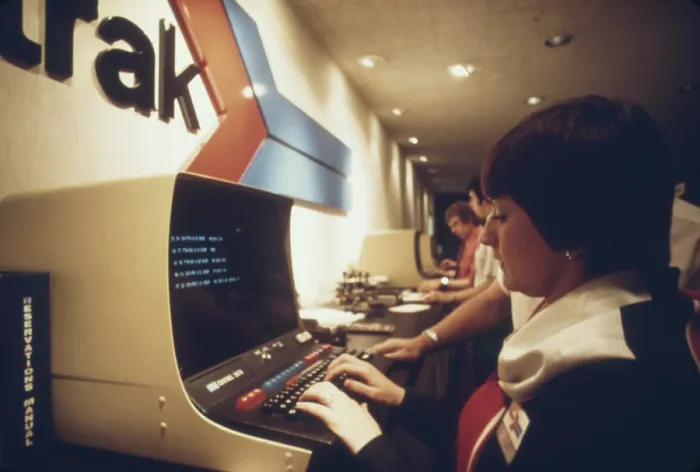 Framed Print : An AMTRAK worker at a computer terminal gets information on available space and fares and can enter reservations