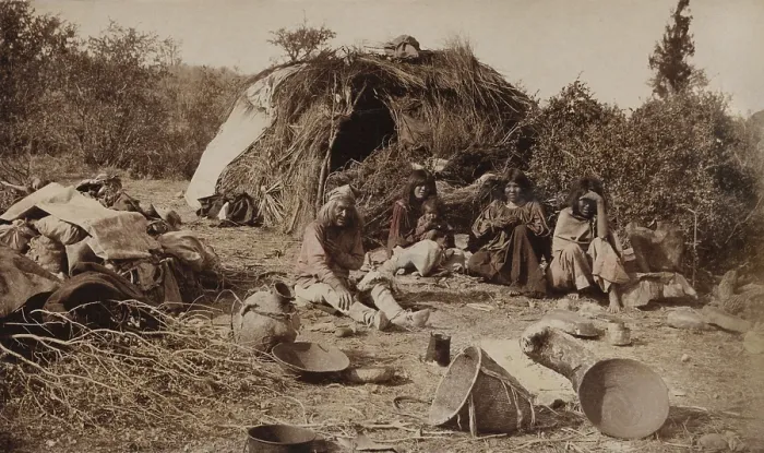 Framed Print : An Apache camp in Texas, ca. 1885, shows young women, one with a baby, and an old man, sitting outside their shelter Framed Print : An Apache camp in Texas, ca. 1885, shows young women, one with a baby, and an old man, sitting outside their shelter