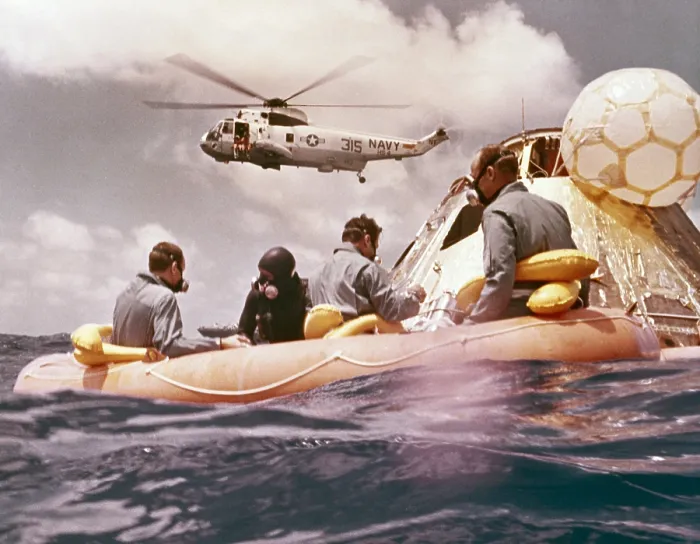 Framed Print : Apollo 12 Pacific recovery. Astronauts are in a life raft near the Command module with a Helicopter hovering above. Nov. 24, 1969