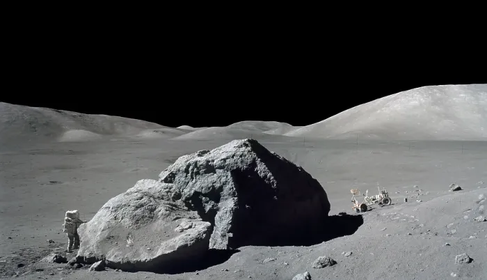 Framed Print : Apollo 17 Geologist-Astronaut Harrison Schmitt standing next to a huge, split lunar boulder. Schmitt and Eugene Cernan travel to this site in the Lunar Rover (at right). Nov