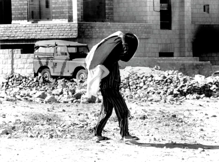 Framed Print : Arab-Israeli War, Jordanian in pajamas (carrying mattress & blankets) walking through war-torn city of Amman, Jordan, September 26, 1970