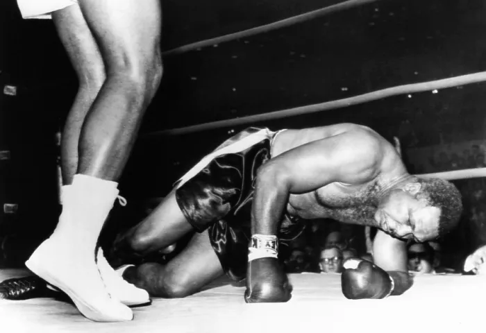 Framed Print : Archie Moore on the canvas in the fourth round of his fight with 20 year old Cassius Clay. Nov. 15, 1962