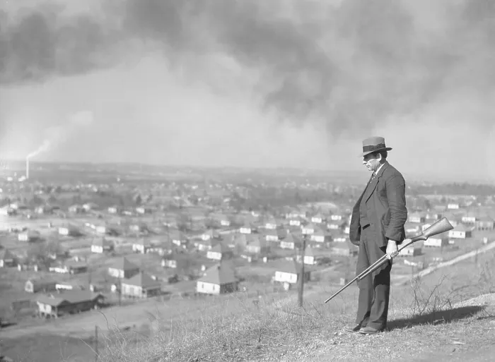 Framed Print : An armed private guard watches over a steel mining company town in Jefferson County, Alabama, in 1937. The New Deal supported labor organization which caused tension in the U.S