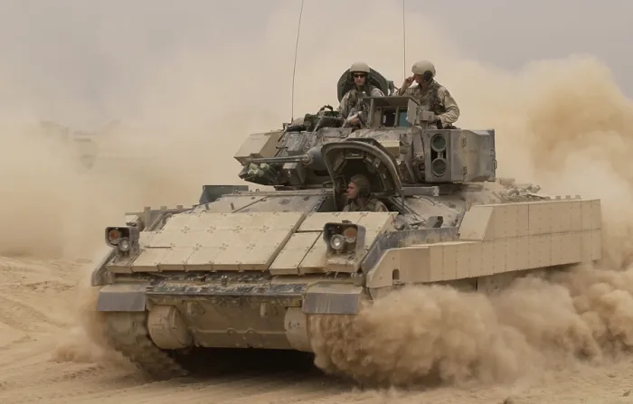 Framed Print : An Army Bradley Fighting Vehicle kicks up dust as it leaves for a mission from Forward Operating Base MacKenzie in Iraq. Oct. 30 2004. (BSLOC_2011_12_161)