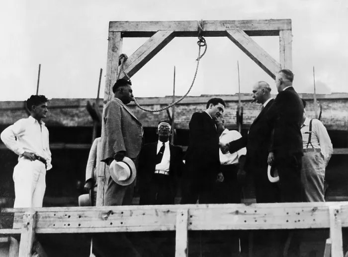 Framed Print : Arthur Gooch shakes hands with Deputy Warden Jess Dunn of the McAlester, Oklahoma penitentiary. Gooch was hanged for kidnapping minutes later, 1936