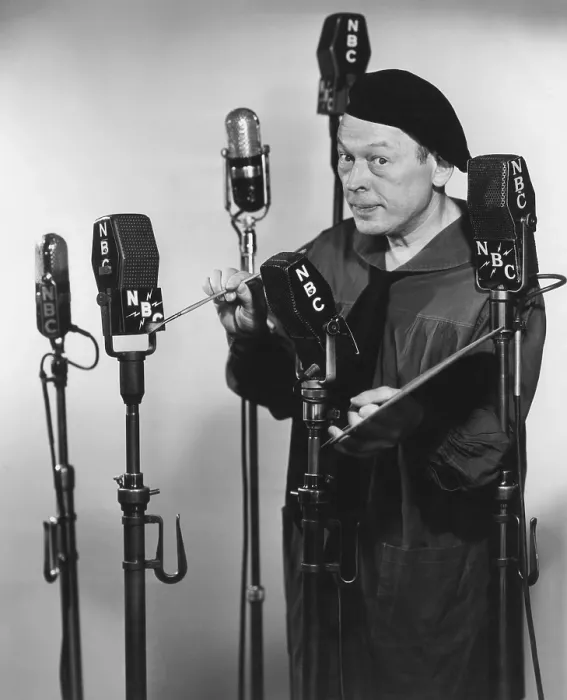 Framed Print : Artist Fred Allen painting the NBCs on the network microphones, 1940s