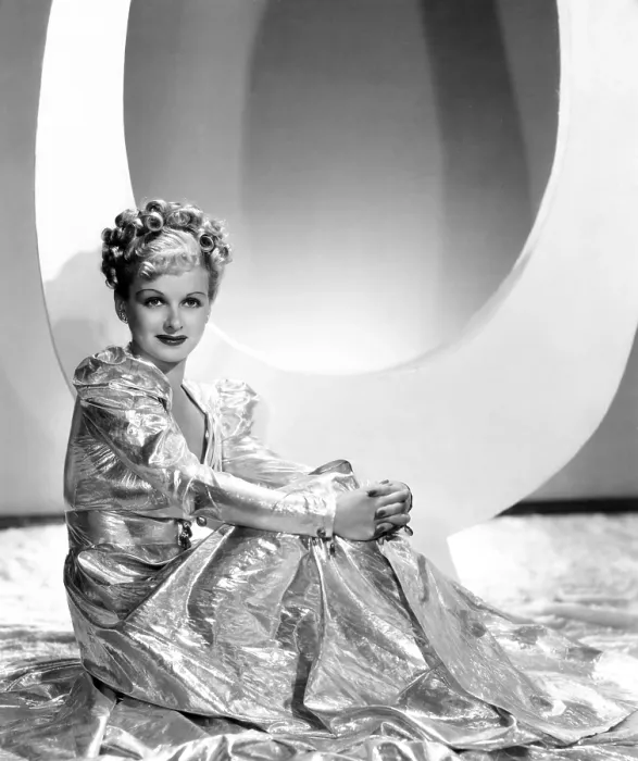 Framed Print : ARTISTS AND MODELS ABROAD, Joan Bennett wearing gold lame negligee designed by Edith Head, 1938