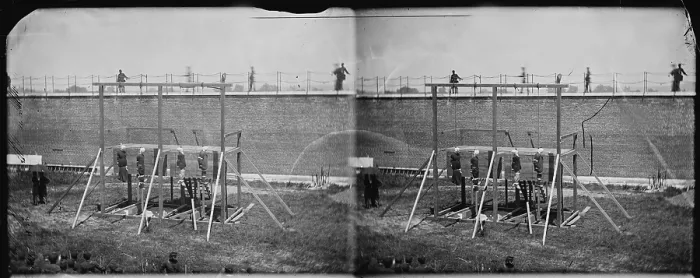 Framed Print : The assassination of President Abraham Lincoln, hanging hooded bodies of the four conspirators, guards only in yard, Washington DC, stereo photograph by Alexander Gardner, July 7