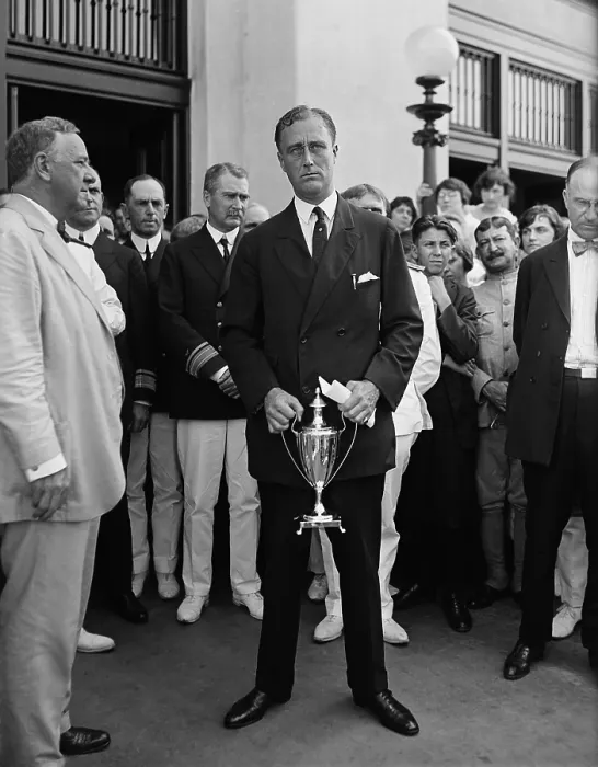 Framed Print : Assist. Navy Sec. Franklin D. Roosevelt standing awkwardly for news photographers with a trophy. At left is his boss, Sec. of the Navy, Josephus Daniels, c