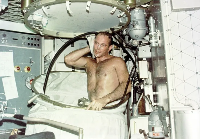 Framed Print : Astronaut Jack R. Lousma, taking a hot bath in the crew quarters aboard Skylab