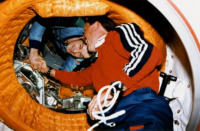 Framed Print : Astronaut Robert Gibson, greets Cosmonaut Vladimir Dezhurov in space. The Space Shuttle docked at the Russian Mir Space Station on June 29, 1995