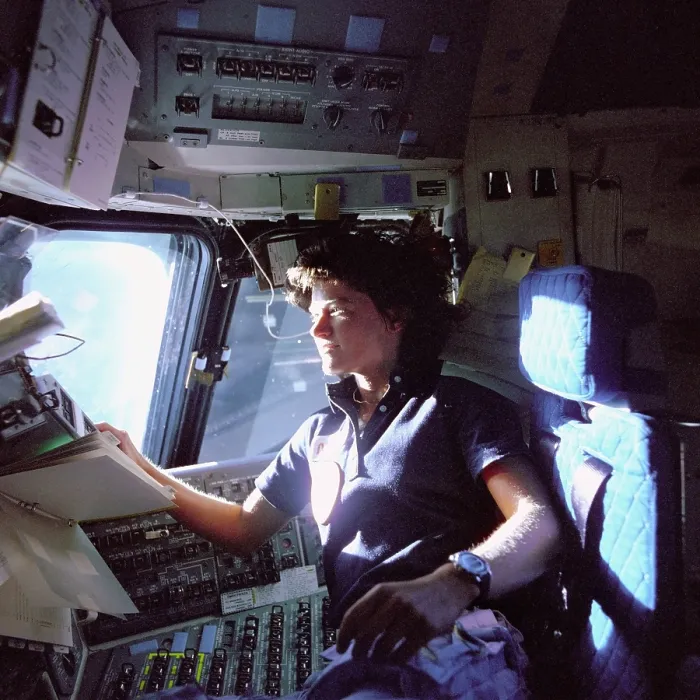 Framed Print : Astronaut Sally Ride monitors control panels from the pilot's chair on the flight deck of the Space Shuttle Challenger. She held her Ph.D