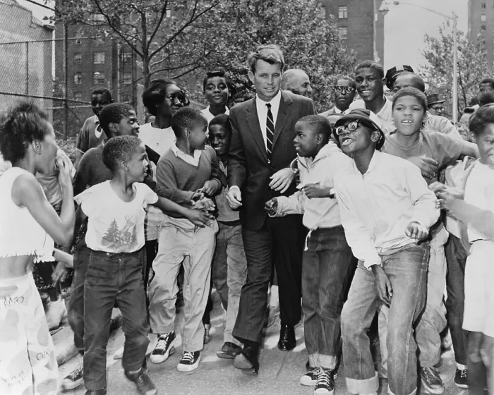 Framed Print : Attorney General Robert Kennedy surrounded by African American children. He was visiting a summer reading program in Harlem at the Morningside Community Center, in Manhattan. Aug