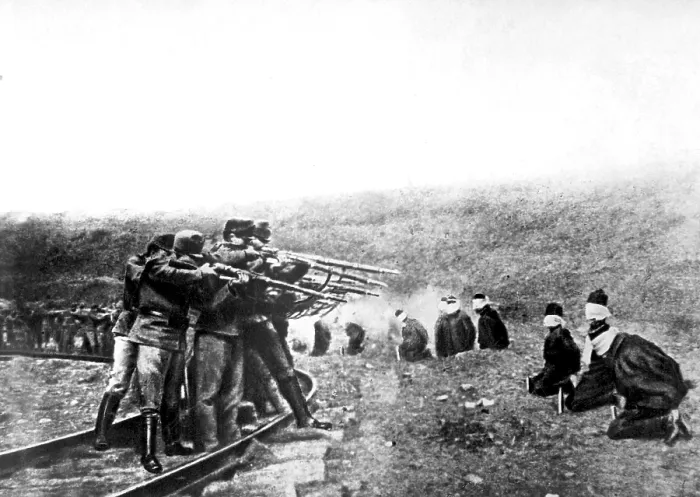 Framed Print : Austrian atrocities in Serbia. A long line of blindfolded and kneeling Serbian men near the Austrian lines were ruthlessly shot at a command
