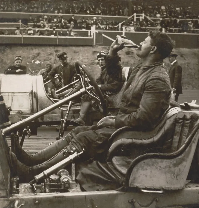 Framed Print : Auto racer, Louis Chevrolet in his open-cockpit automobile drinking Coca-Cola