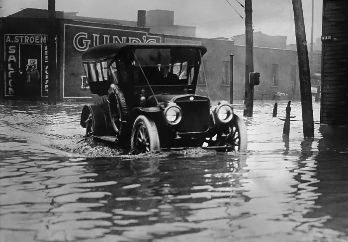 Framed Print : An automobile drives through axel high water on a flooded Cleveland street, probably in 1913