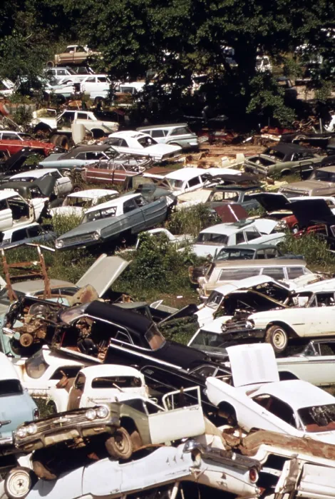 Framed Print : An automobile junkyard. Wrecked car parts were sold for auto repairs and whole cars for recycling as scrap steel. Ca. 1973-75