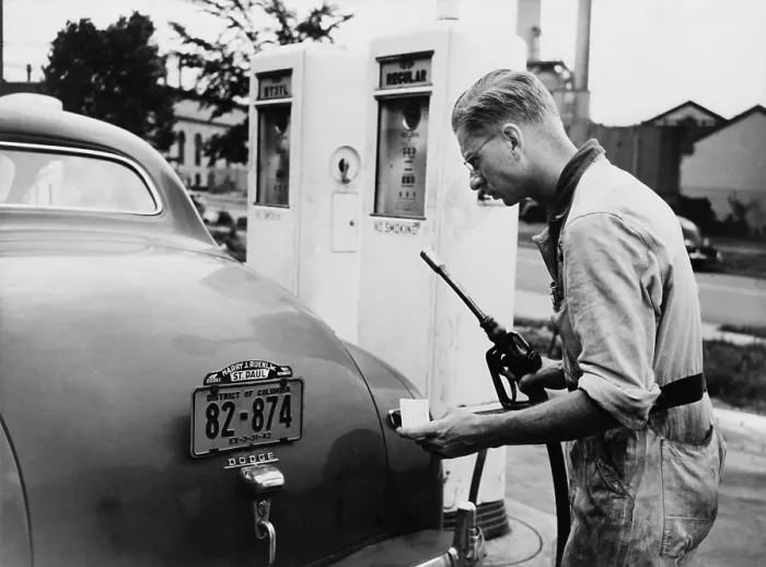 Framed Print : An automobile service station attendant measures out gasoline in accordance with the World War II gasoline rationing. July 1942