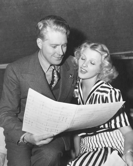 Framed Print : BALALAIKA, from left: Nelson Eddy, Ilona Massey studying a music score on set, 1939