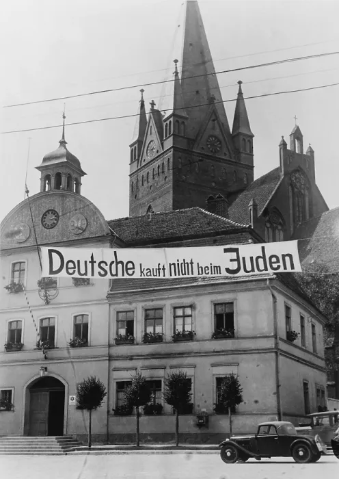 Framed Print : Banner reading Deutsche kauft nich beim Juden (Germans don't buy in Jewish shops) suspended over a street in Greifenberg, Pommerania (now Poland). 1935 Framed Print : Banner reading Deutsche kauft nich beim Juden (Germans don't buy in Jewish shops) suspended over a street in Greifenberg, Pommerania (now Poland). 1935