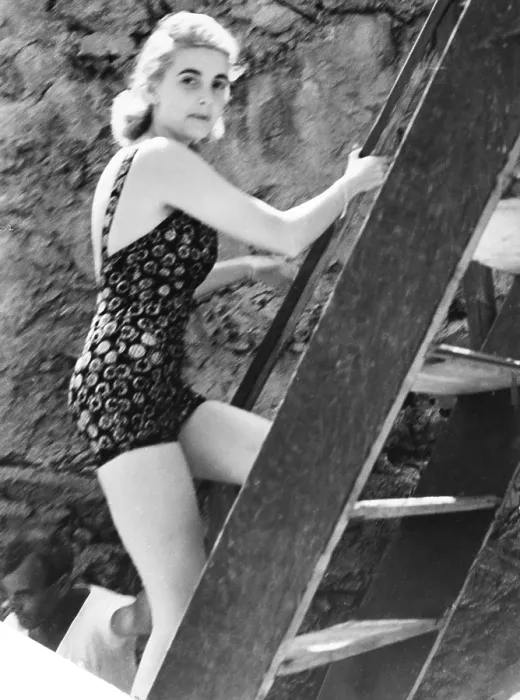 Framed Print : Barbara Hutton, now Countess Von Haugwitz-Reventlow, summering on Capri, Italy. She leased the Villa Lo Smeraldo and is climbing a ladder after a dip in the Mediterranean. Aug