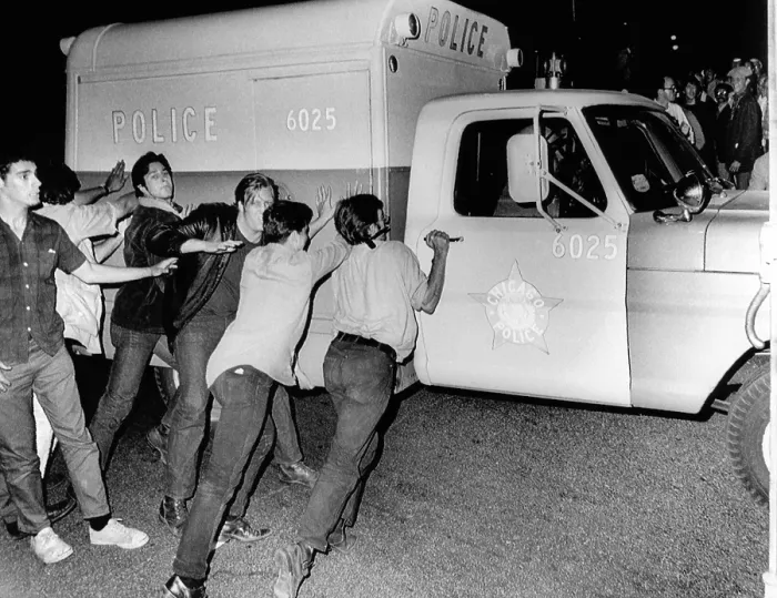 Framed Print : Battle of Michigan Avenue in Chicago, during the 1968 D emocratic National Convention. Anti-war demonstrators try t o push over a Chicago Police vehicle. Aug Framed Print : Battle of Michigan Avenue in Chicago, during the 1968 D emocratic National Convention. Anti-war demonstrators try t o push over a Chicago Police vehicle. Aug
