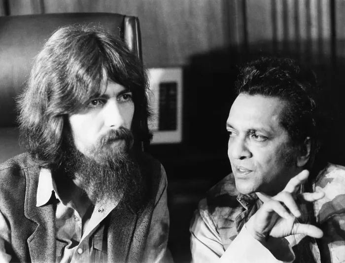 Framed Print : Former Beatle George Harrison (left) and Indian musician Ravi Shankar talk to newsmen in New York. July 27, 1971