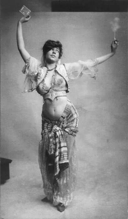 Framed Print : Belly dancing, woman in belly-dancing costume smoking and holding package of cigarettes, photograph, 1900