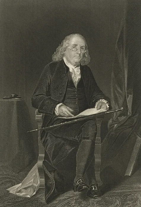 Framed Print : Benjamin Franklin, holds a document while seated in a chair. Full length portrait by Alonzo Chappel, 1863. (BSLOC_2019_4_102)