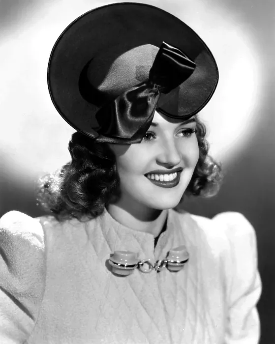 Framed Print : Betty Grable, modeling a tan felt hat with brown satin trim, 1939