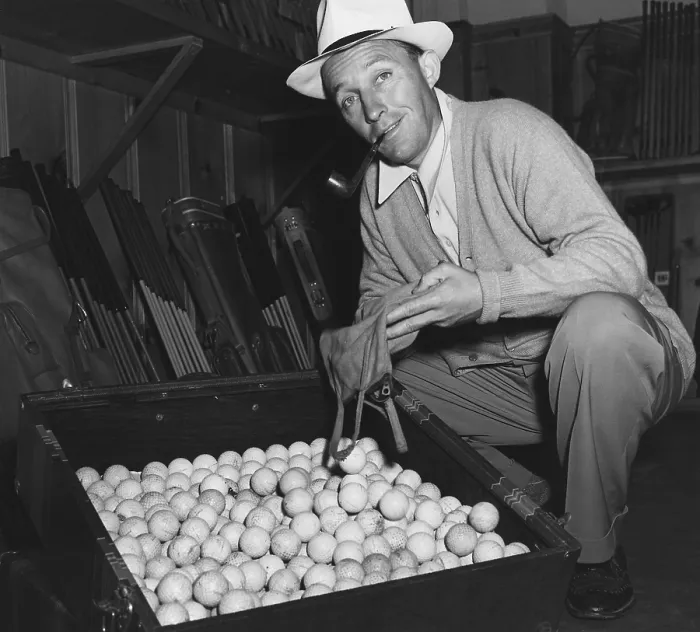 Framed Print : Bing Crosby contributes his golf balls the World War 2 scrap rubber drive. Ca. 1943. (BSLOC_2013-12_137)