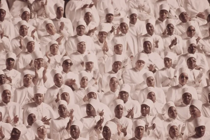 Framed Print : Black Muslim women dressed in white applaud Elijah Muhammad's Annual Savior's Day message. March 1974
